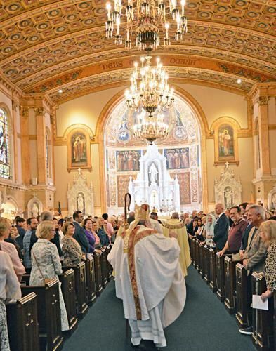 Bishop Barbarito processing down the center isle of the Basilica of St. Edward