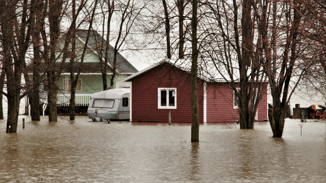 Flood waters surround a red garage