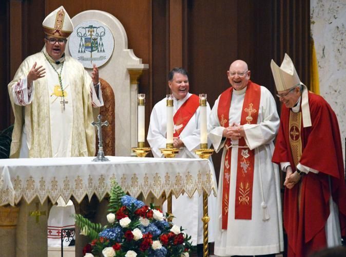 At the end of the anniversary liturgy, Bishop Manuel de Jesús Rodríguez shares a laugh with Bishop Barbarito, Fr. Chuck Nortabartolo and Deacon Greg Quinn.