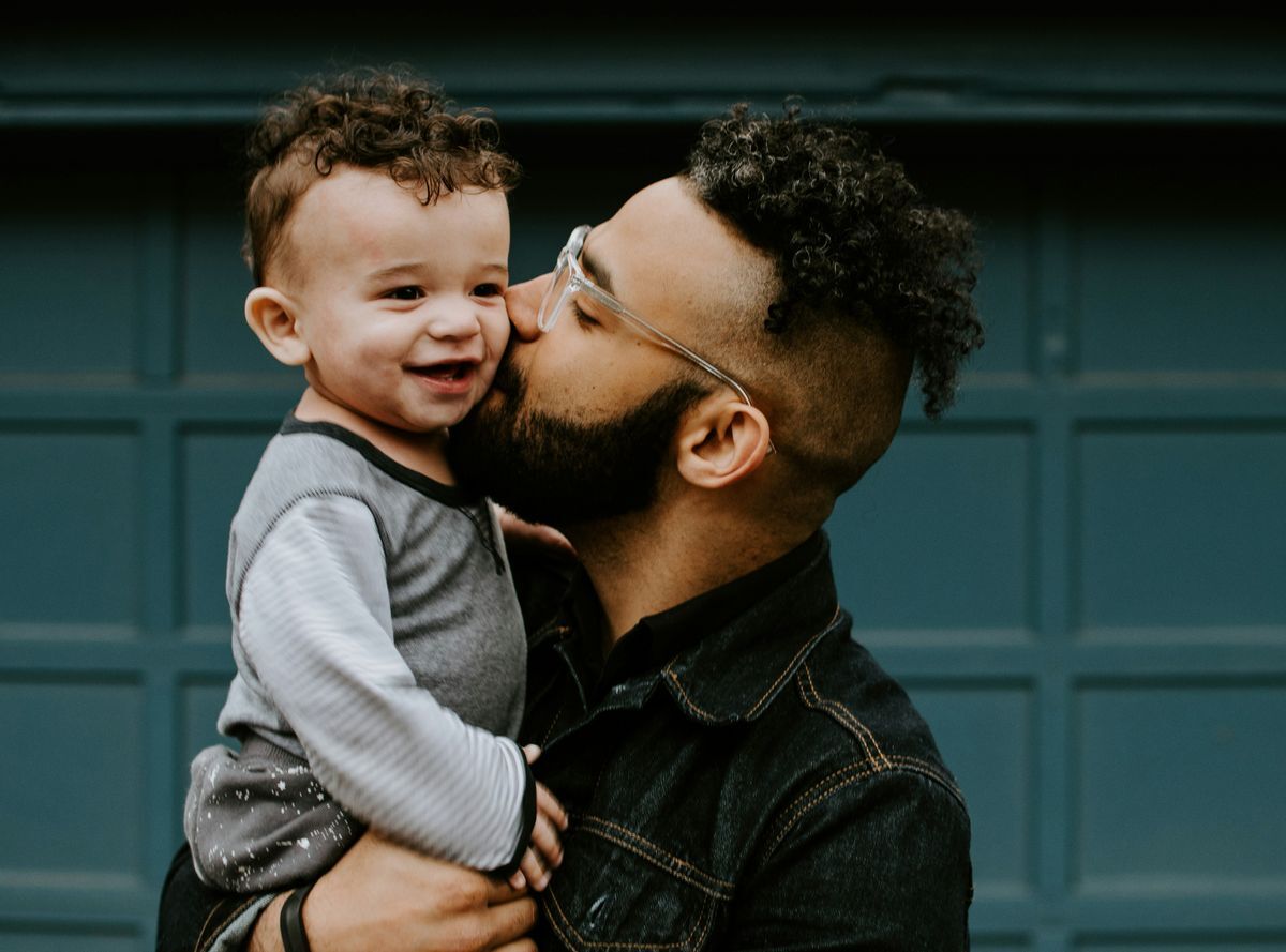 Man kissing baby's cheek