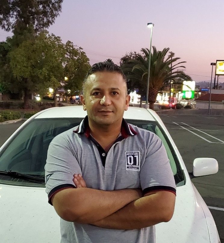 Man standing in front of car.