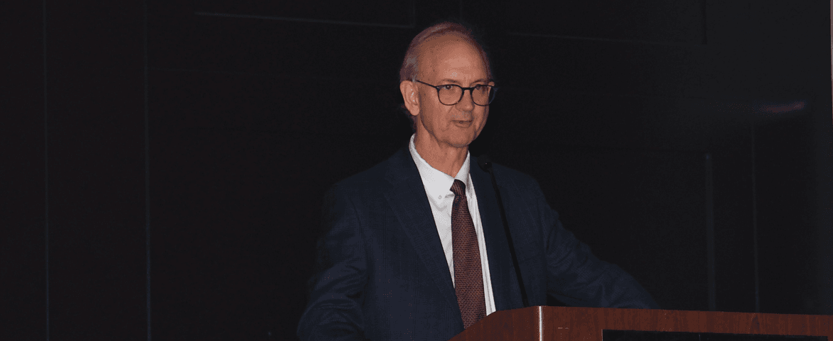 man speaking at a podium 