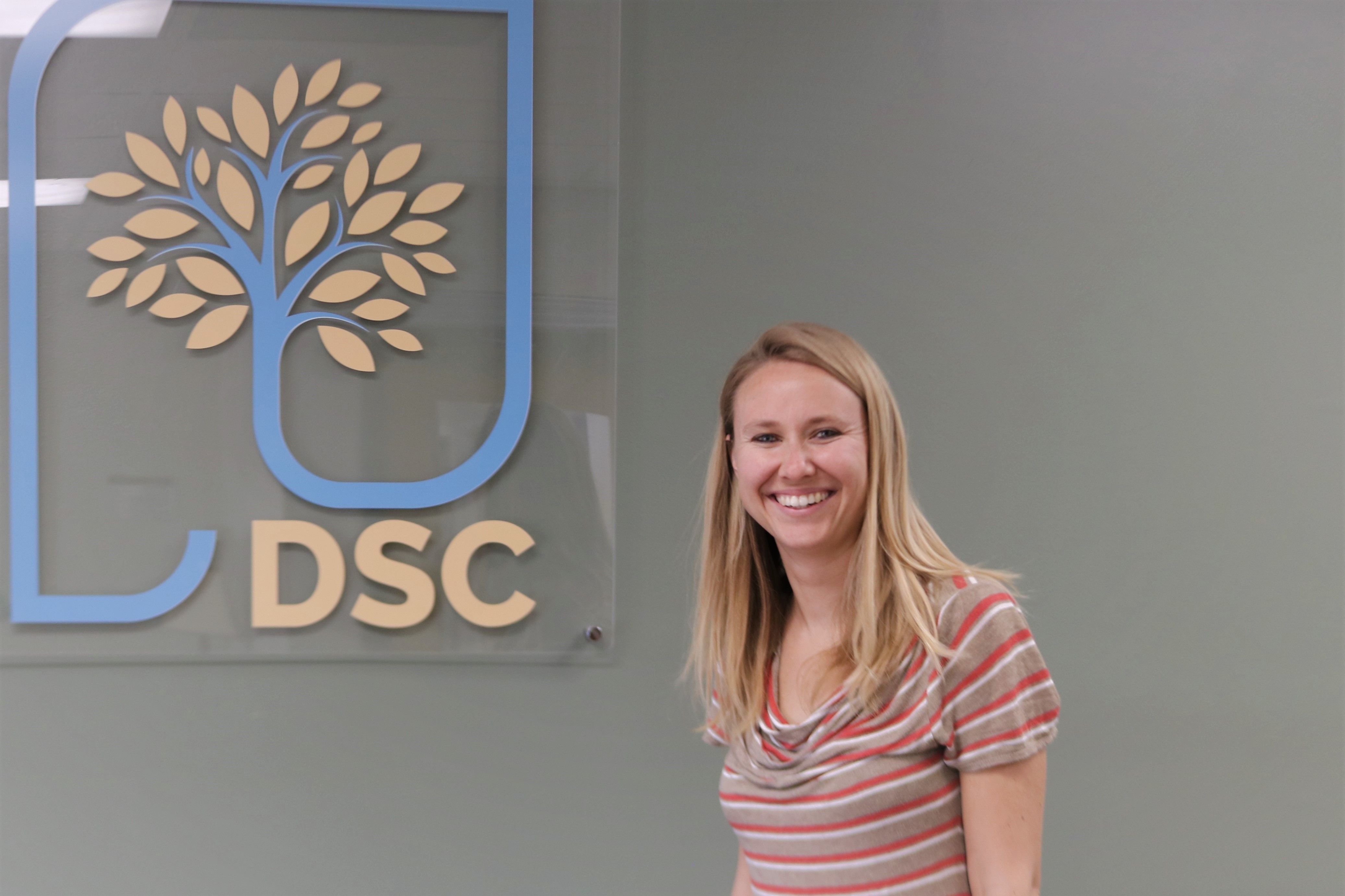 Woman standing by DSC logo