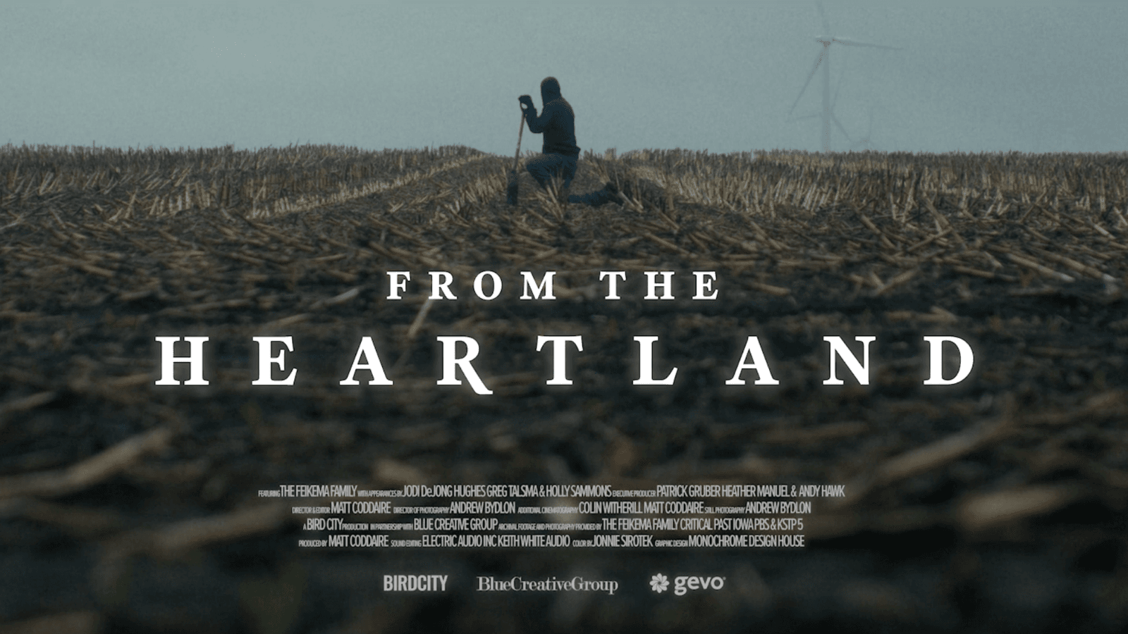 Movie poster for From the Heartland documentary of a farmer kneeling in a field of crops