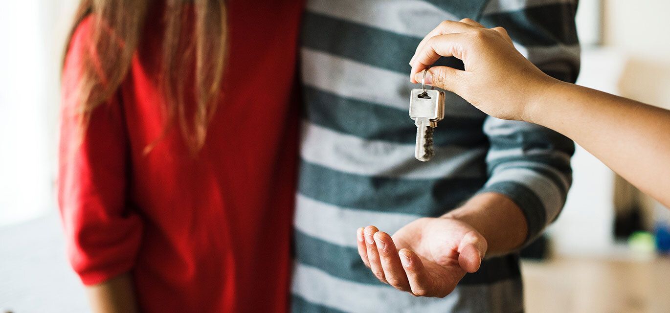 Couple getting a key to their new home.