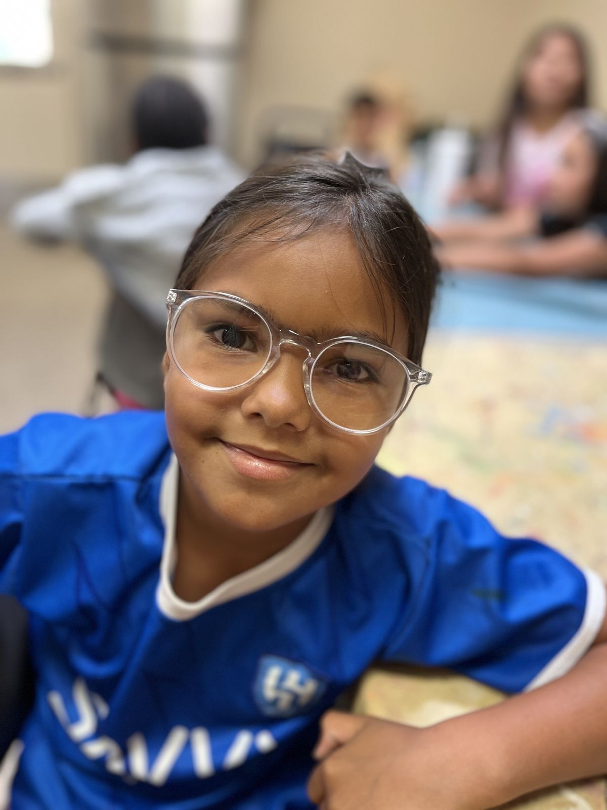 Smiling female student with white framed glasses