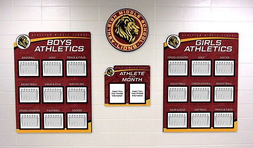 School hallway with athletic team photo displays for boys and girls teams, custom signs