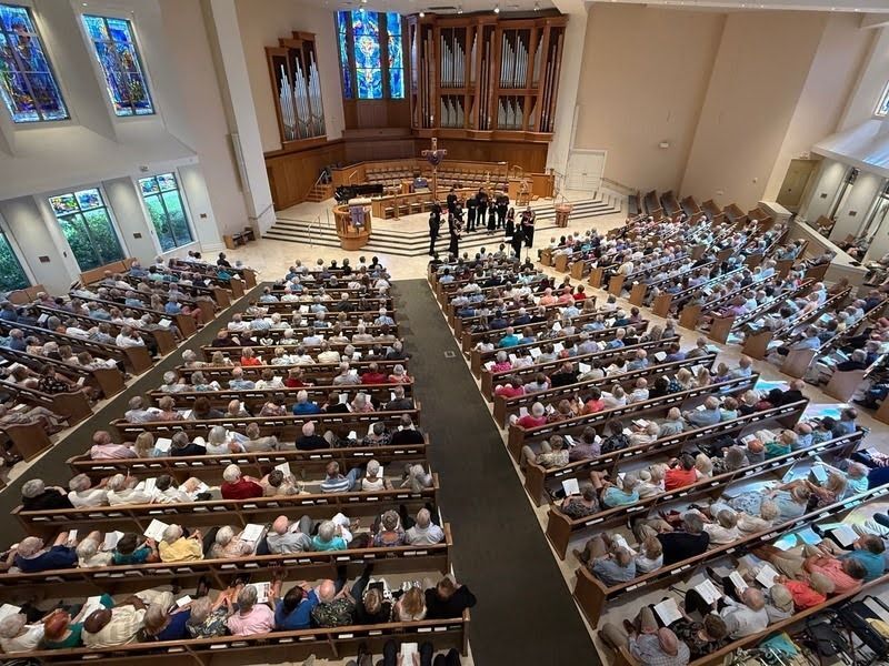 The Seraphic Fire choir performs in front of the alter in a church in front of a crowded audience in Naples, Florida.