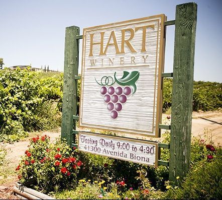 M4770 - Two Rustic   6 " x 6" Cedar Wood Posts Supporting  a Large Hart Winery Sign .