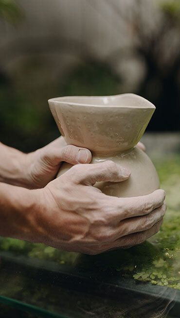 Hands Holding Clay Pot