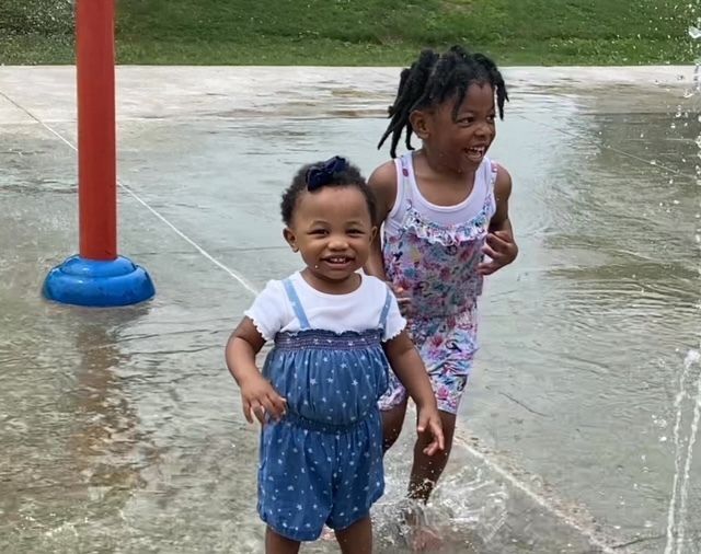 Two children playing at a splashpark