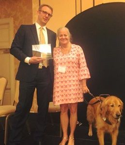 Mark Dunning and Moira Shea, with her guide dog, Finnegan, are shown presenting the award in honor of Dr. Kimberling. (Dr. Kimberling not pictured.)