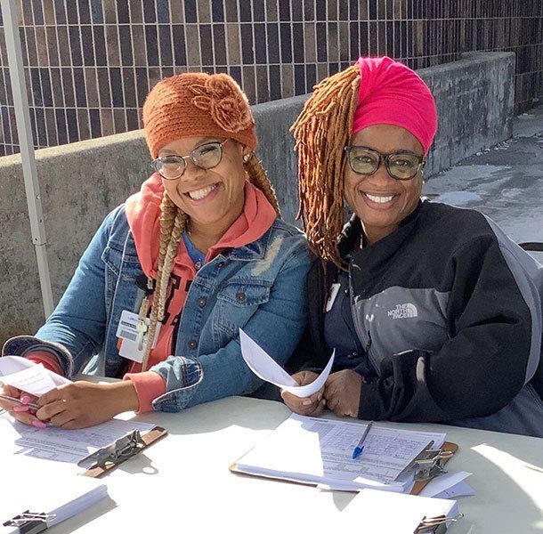 Two smiling woman volunteers.