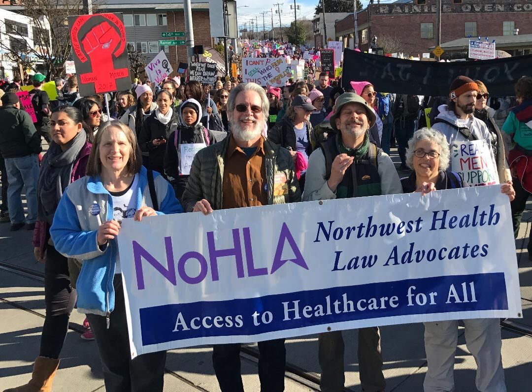 Janet at a rally, marching with the NoHLA banner.