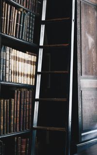 Ladder in front of bookshelf at library