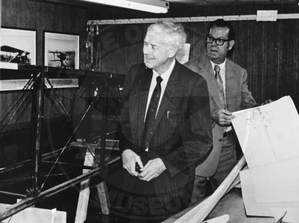 Charles Lindbergh and George Dade examining his Jenny