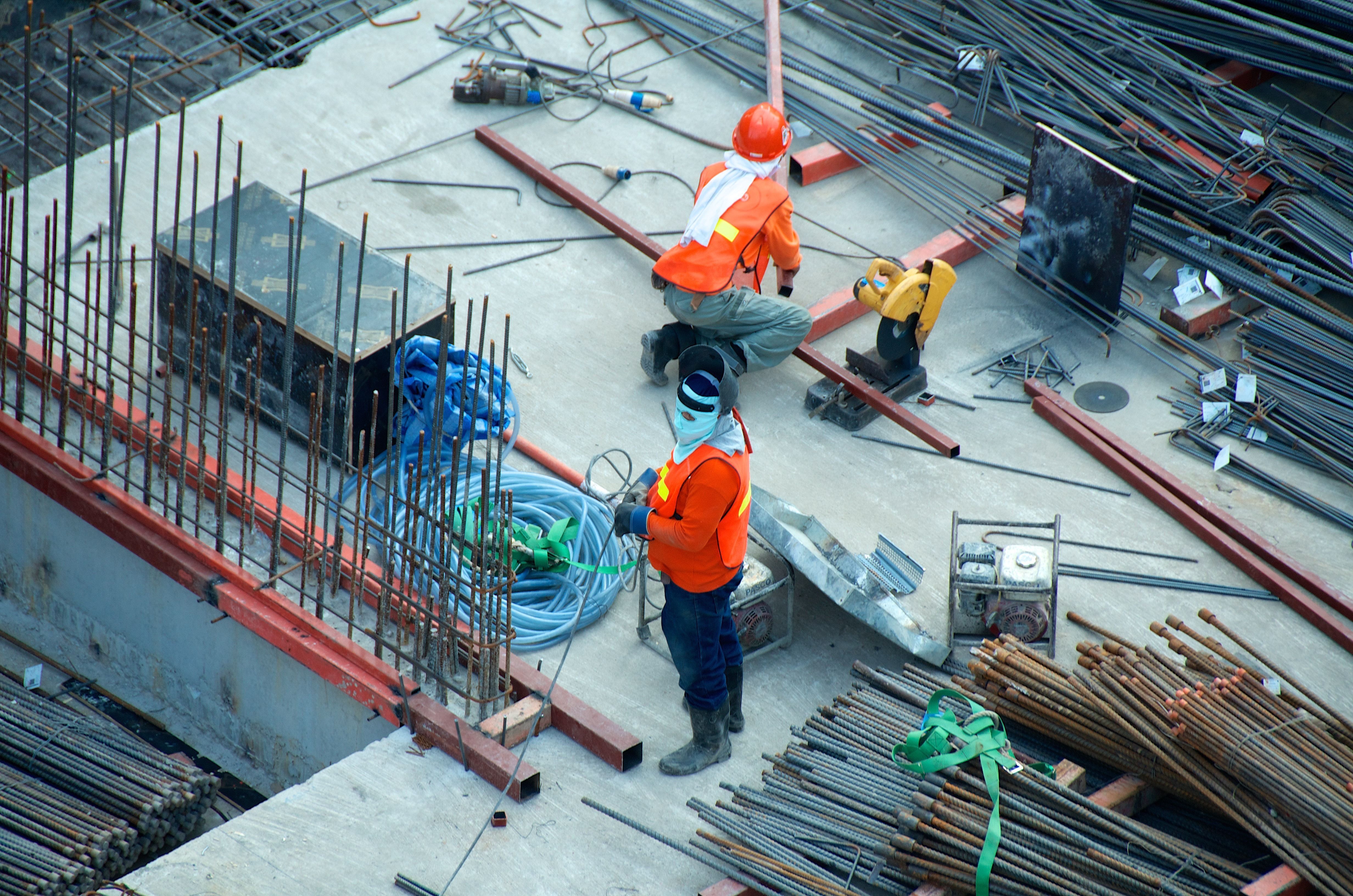 Workers on a construction site building the foundation of a structure.