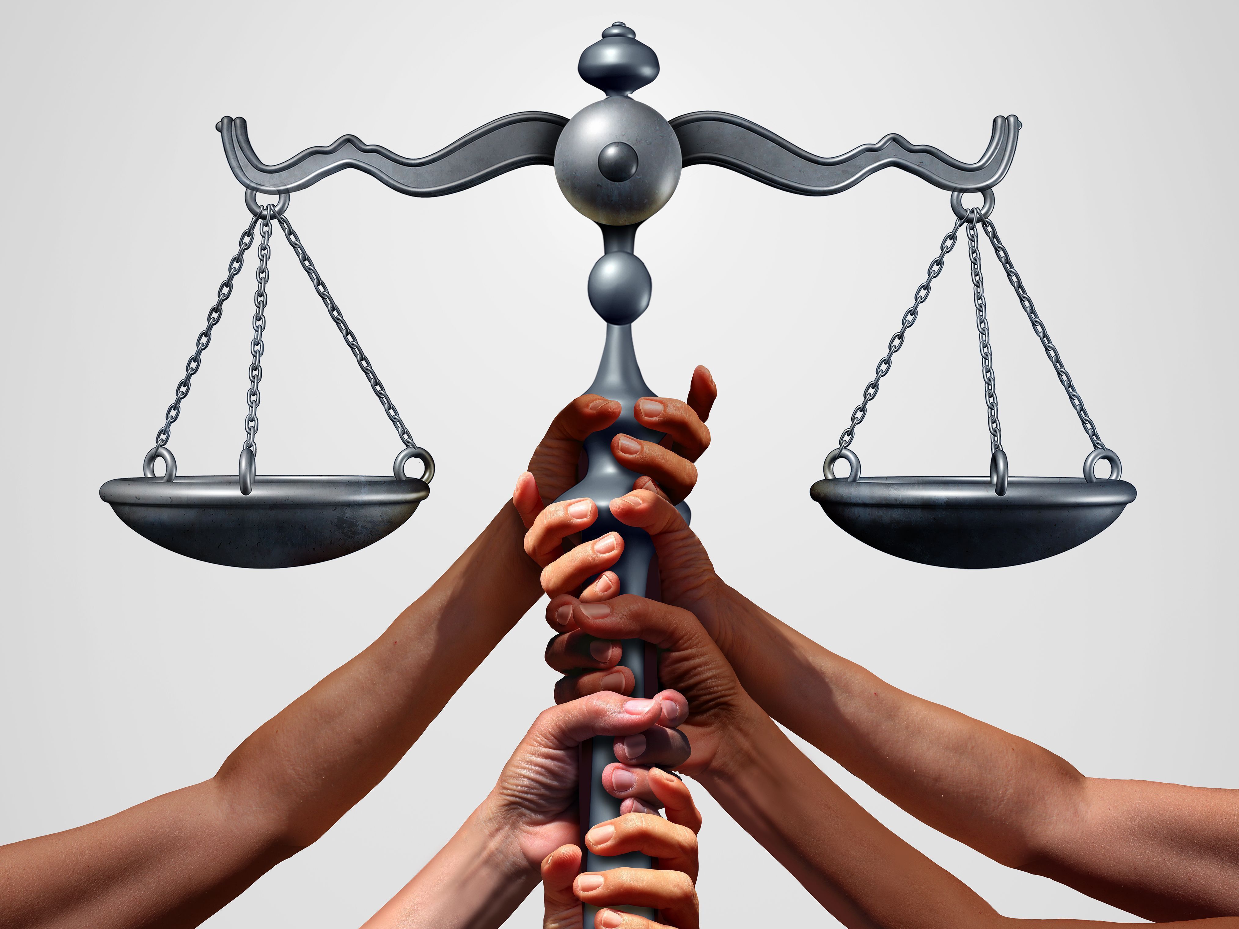 Diverse people extending their arms to hold up the scales of justice