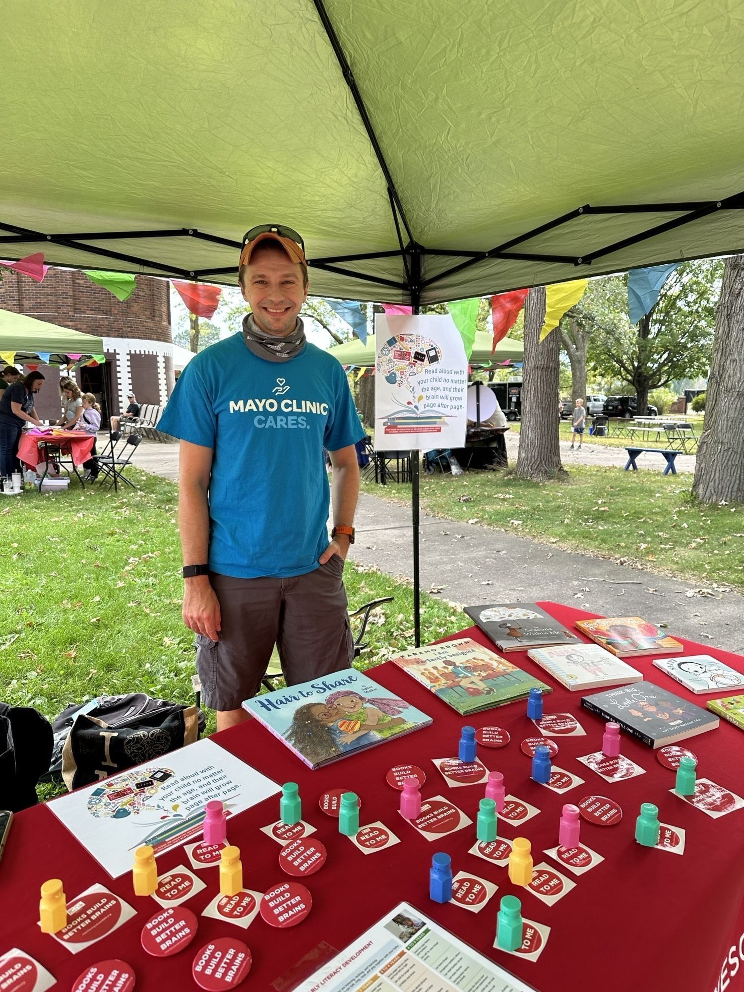 Dr. Gregory volunteers at RORMN table with stickers and books