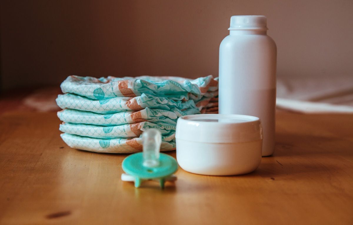 image of baby care products and stack of diapers