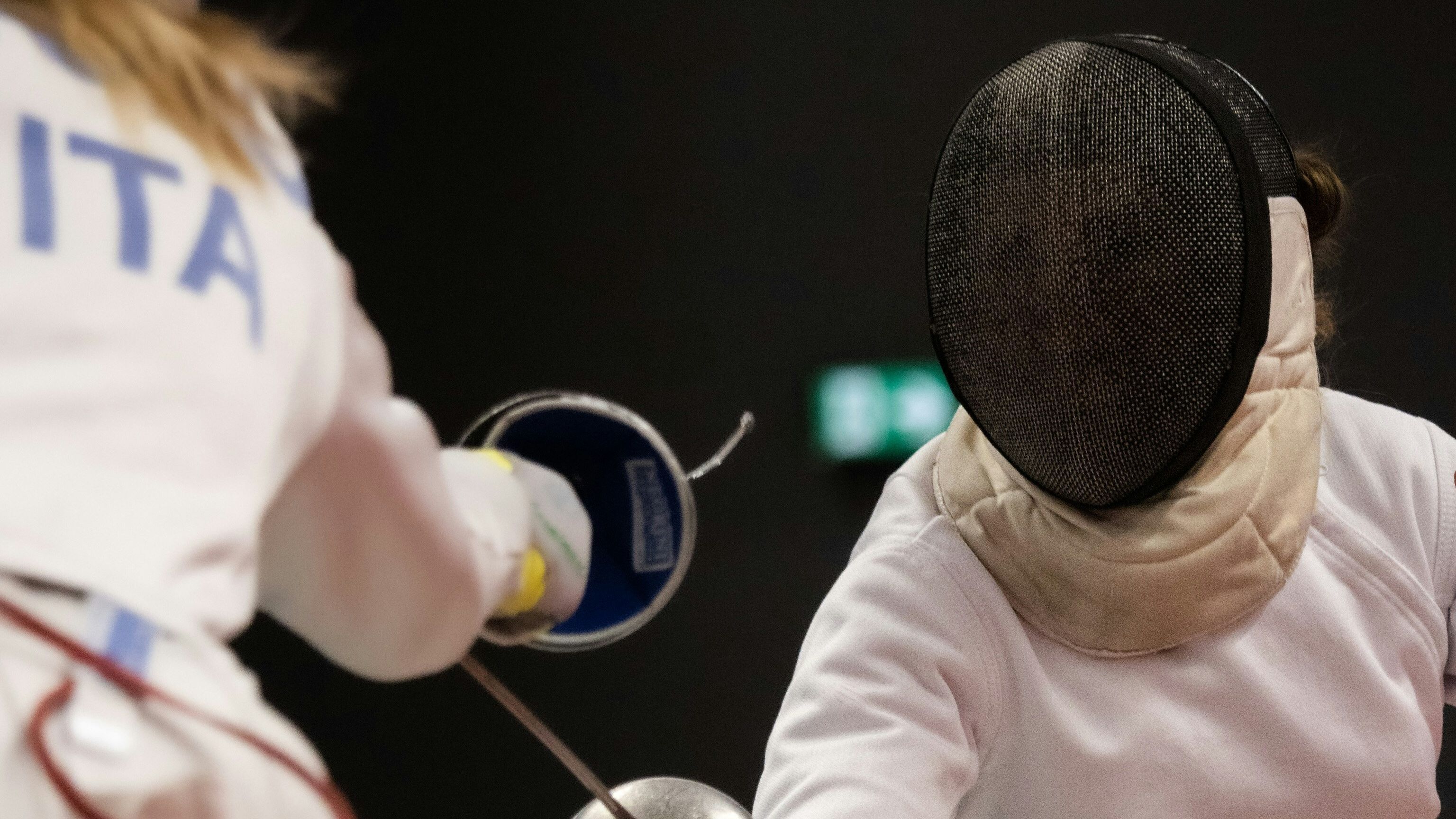 Two people fencing.