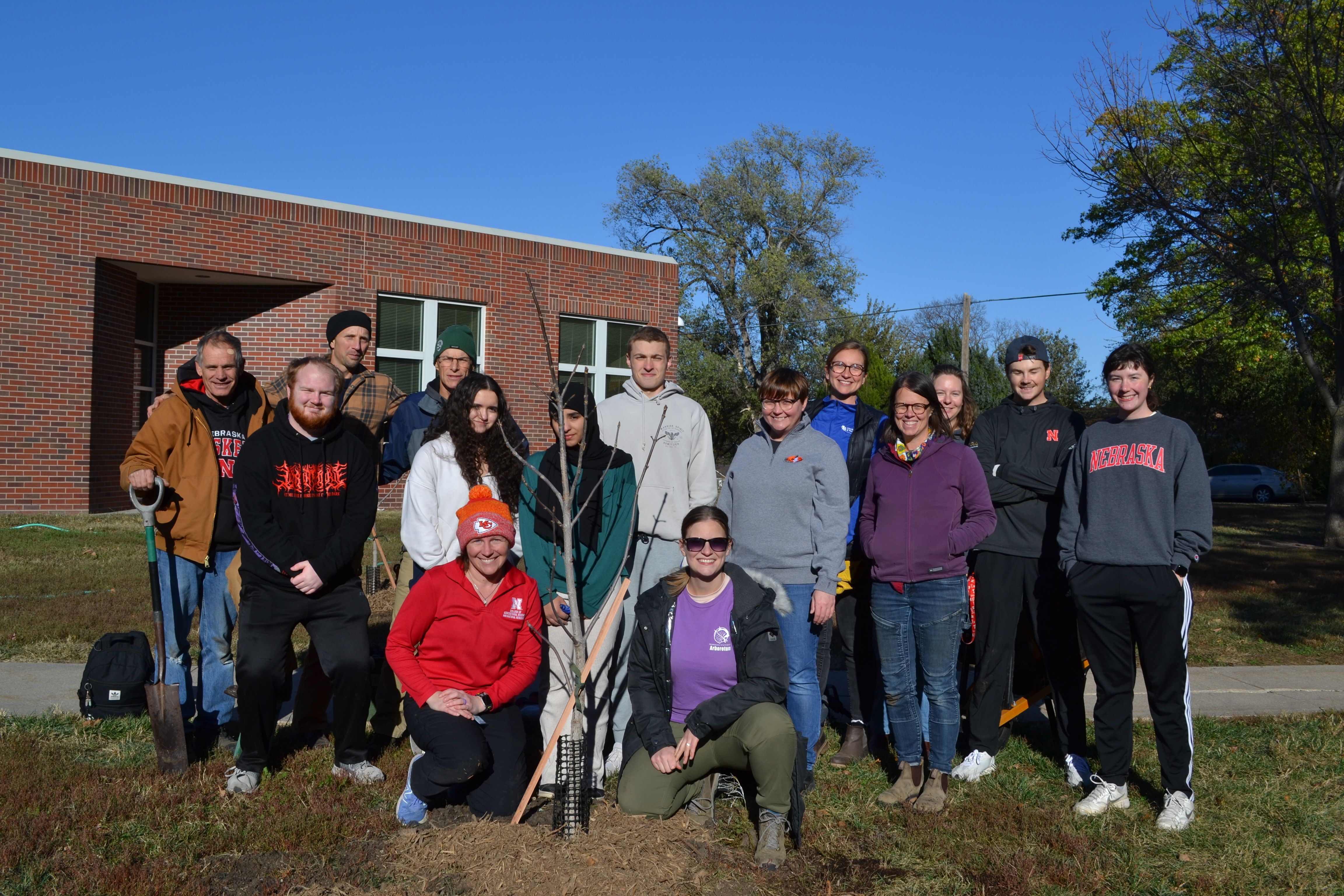 Students at Northeast High School in Lincoln helped plant 10 new trees. 