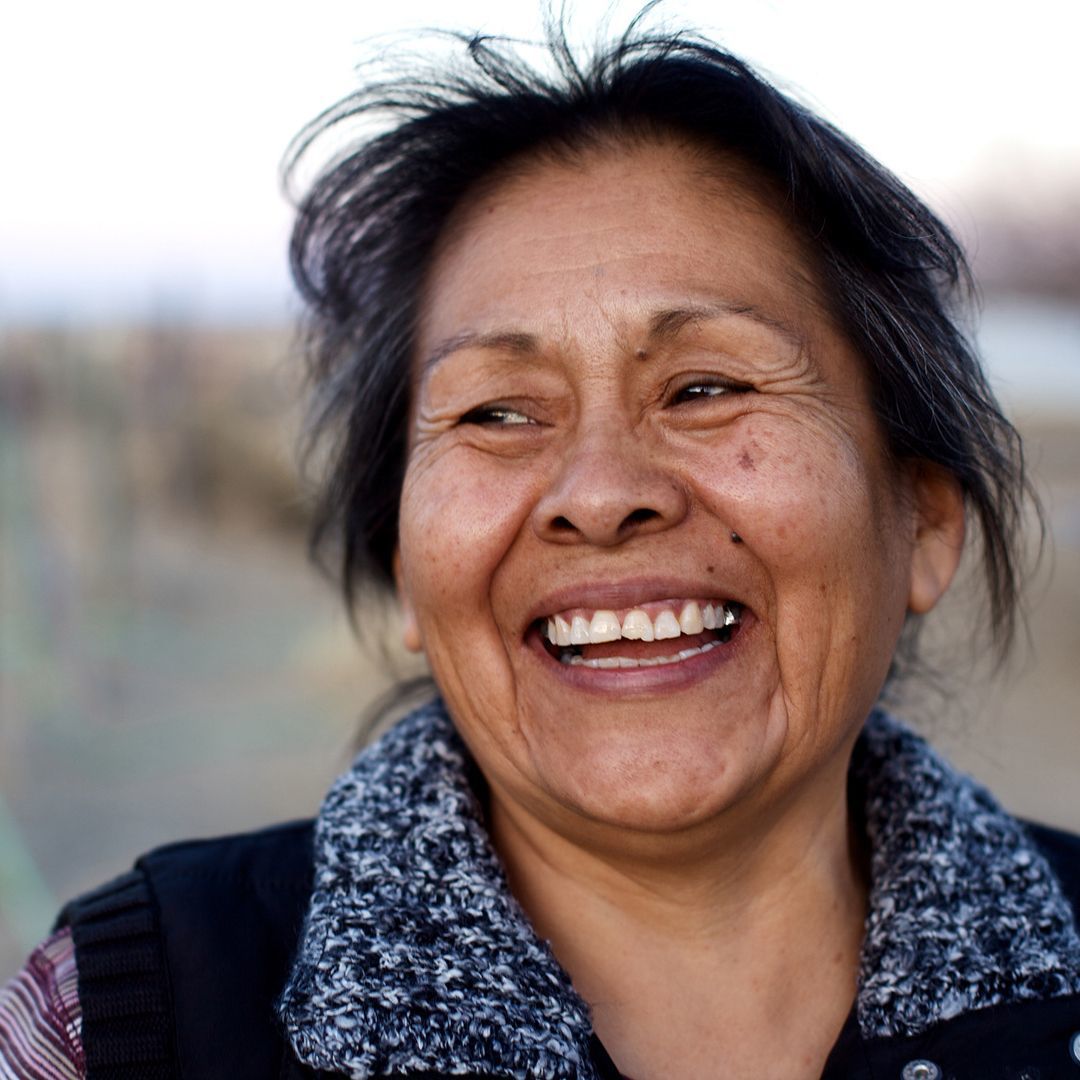 Native American woman smiles in front of horizon