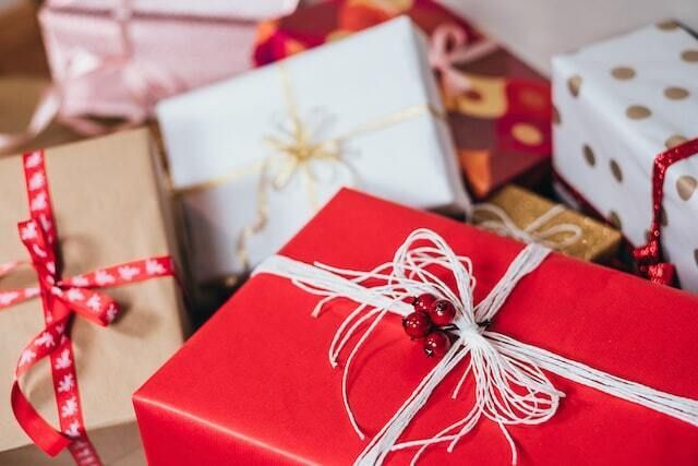 Red and white and brown Kraft paper wrapped holiday gifts.