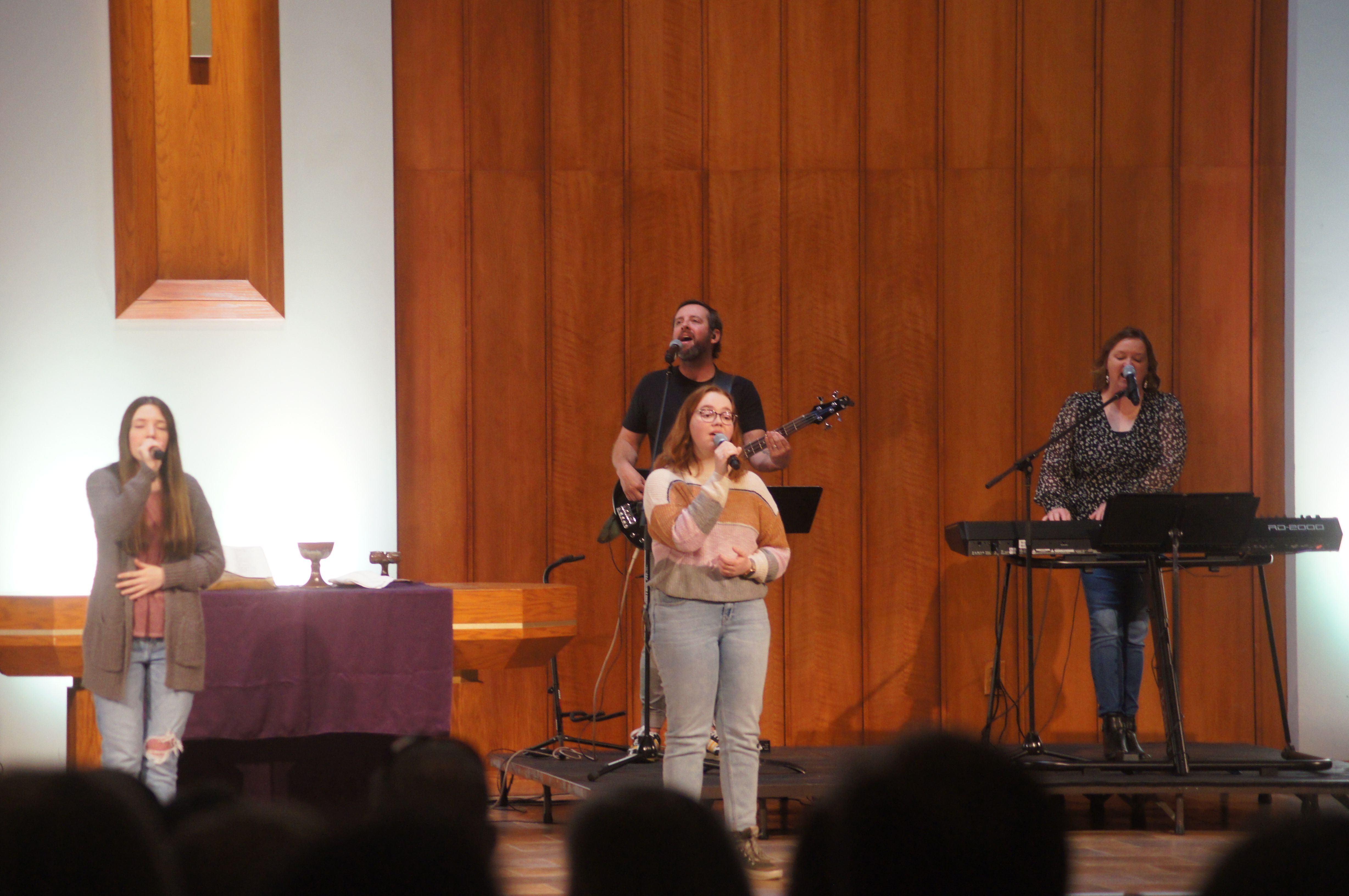 Church congregation greeting each other.