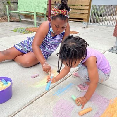 Girls drawing with chalk