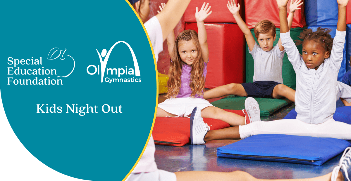 kids in a gym on a mat with hand up