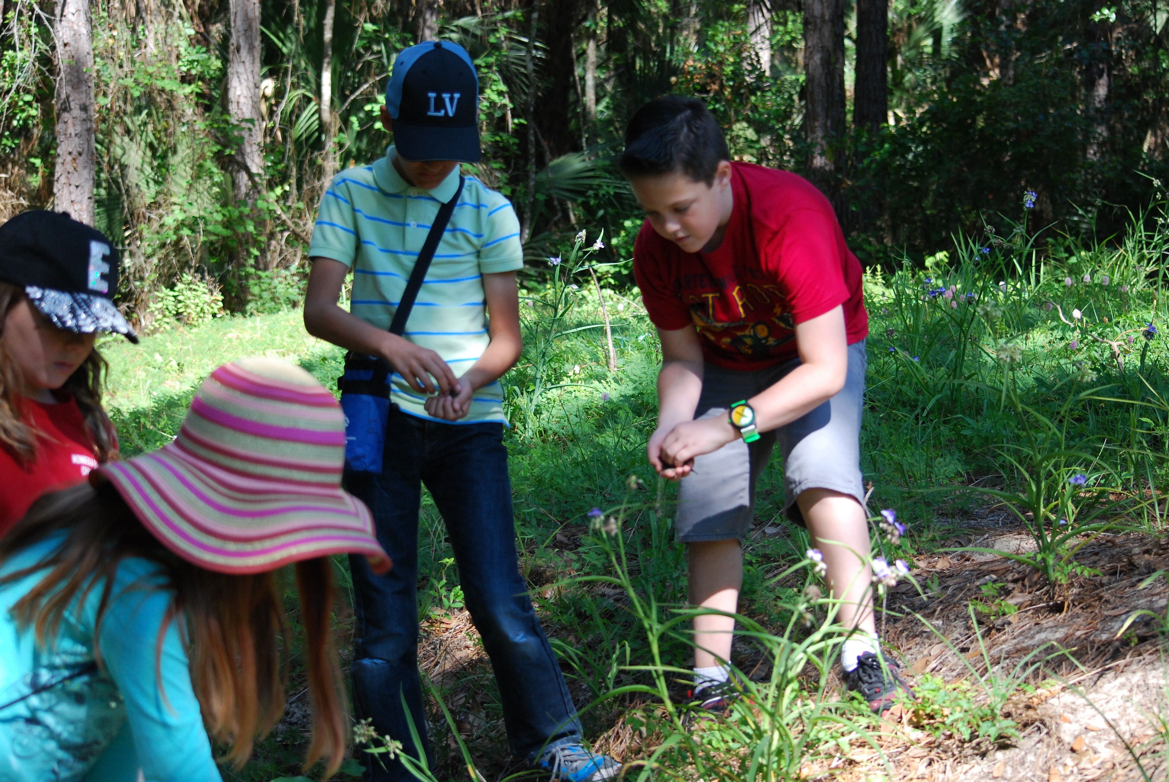 Students examing items found along one of the trails to the lake. 
