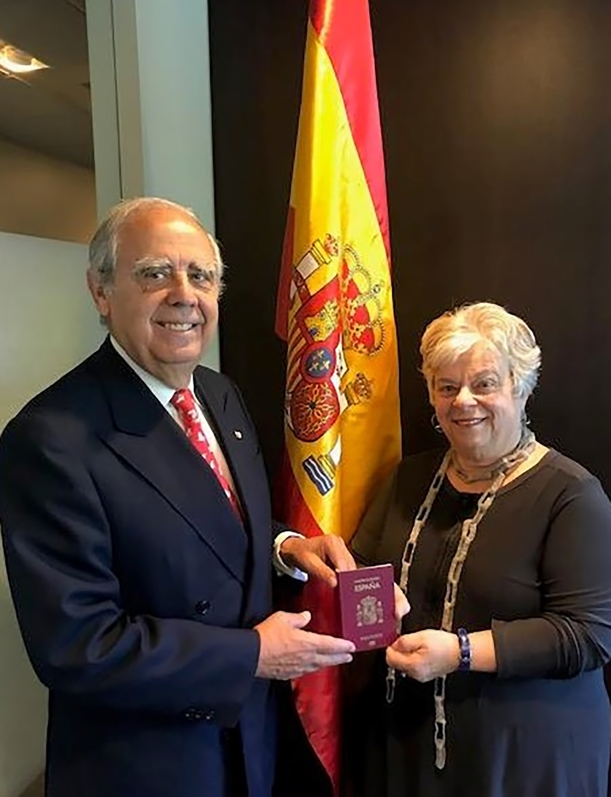 Doreen being presented her new Spanish passport by the Honorary Consul of Spain, Luis Fernando Esteban.