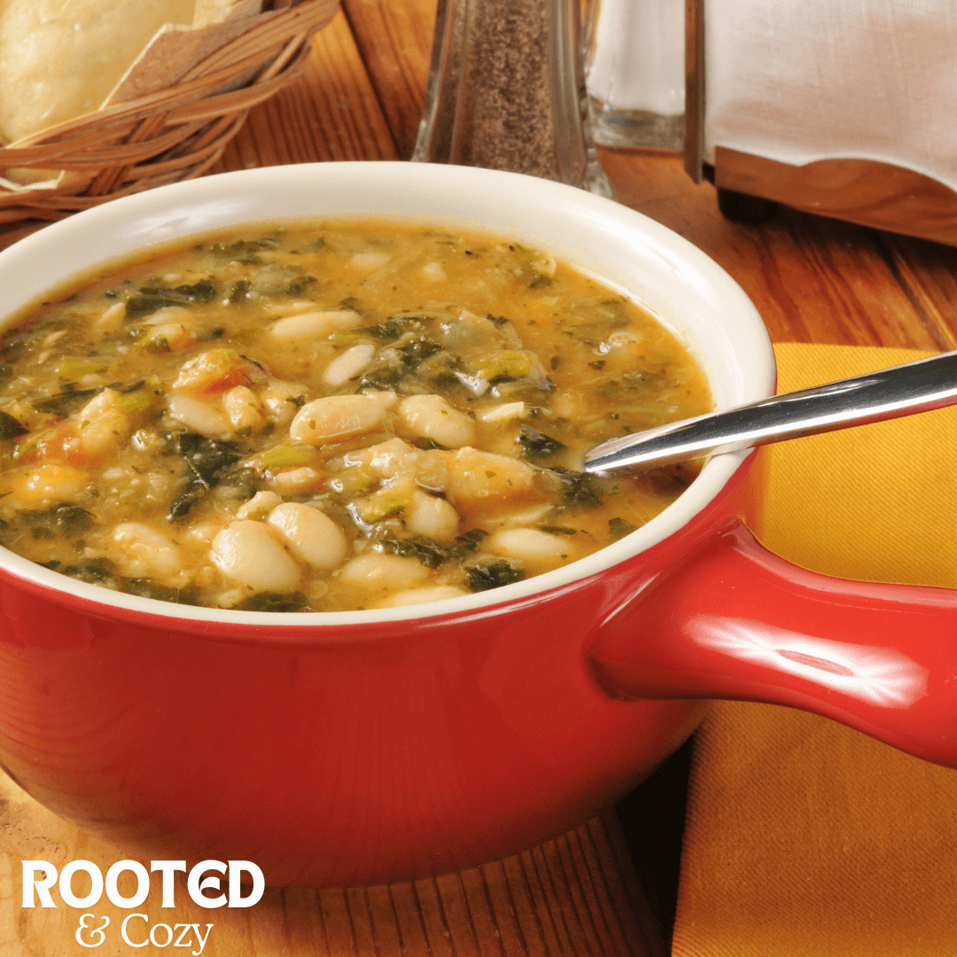 Bowl of white bean soup with greens.