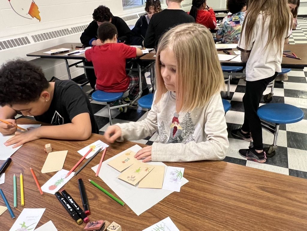 Students decorating seed packets