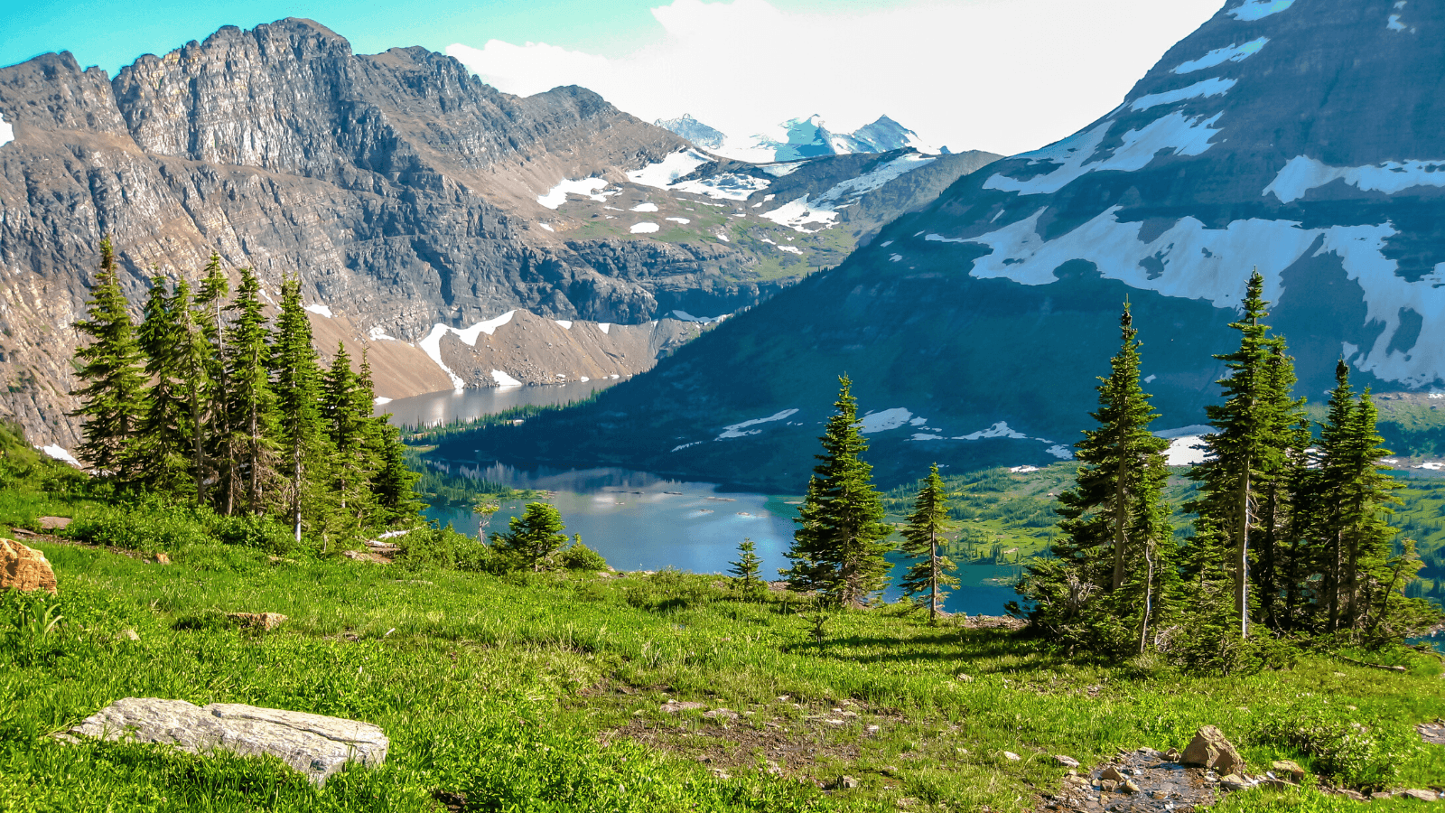 Sunny mountain valley in Glacier National Park with lake