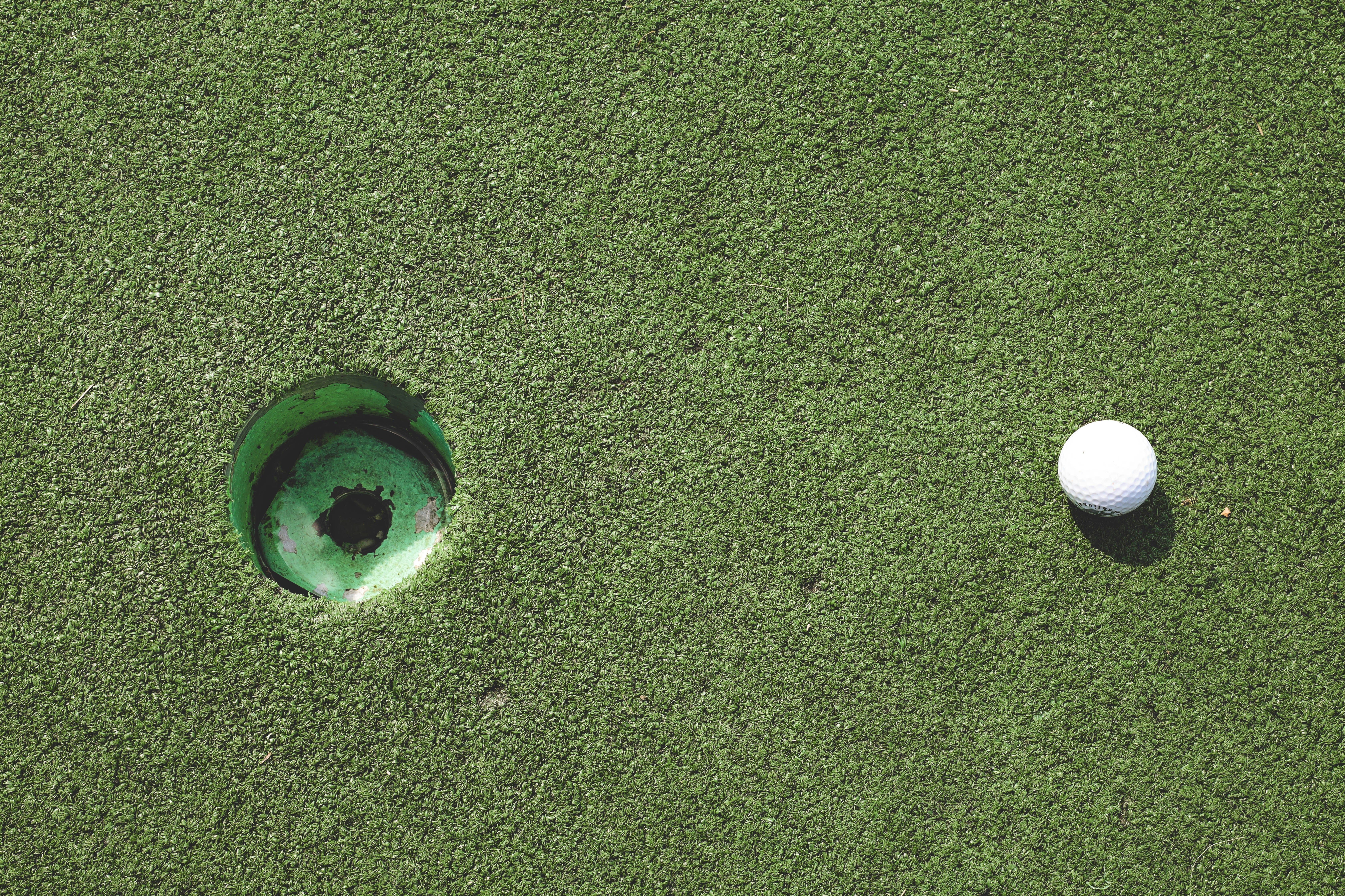 putting green hole with golf ball