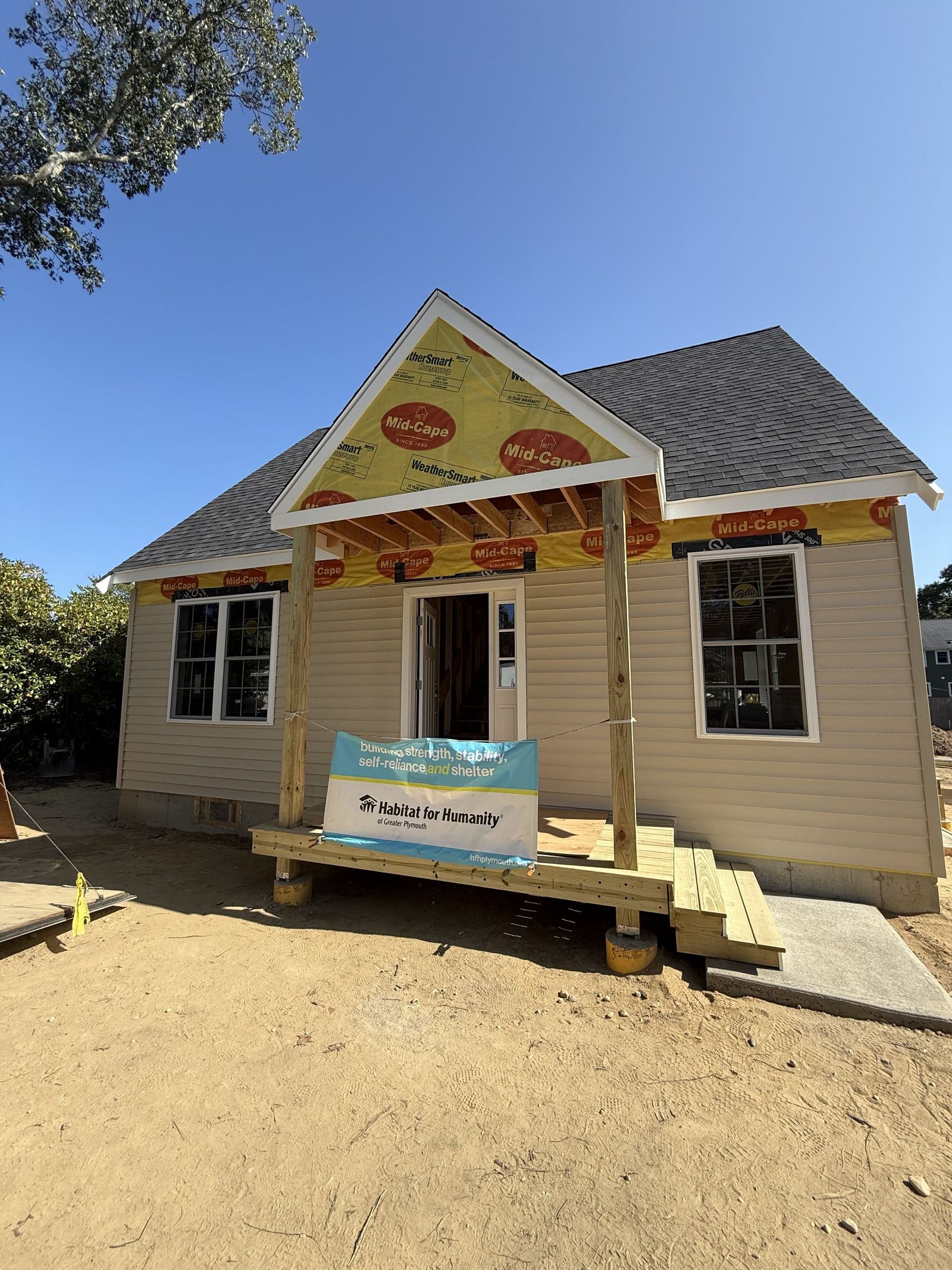 Photo of the exterior of a home with partial siding complete
