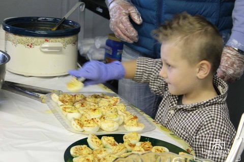 Child serving at CARE Community Center Thanksgiving Day Meal 