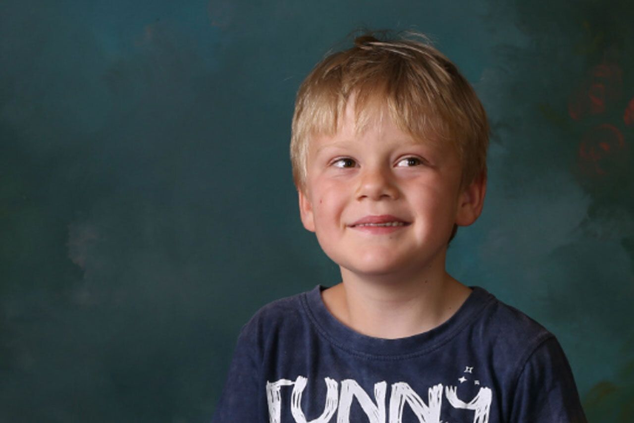Young smiling boy looking up