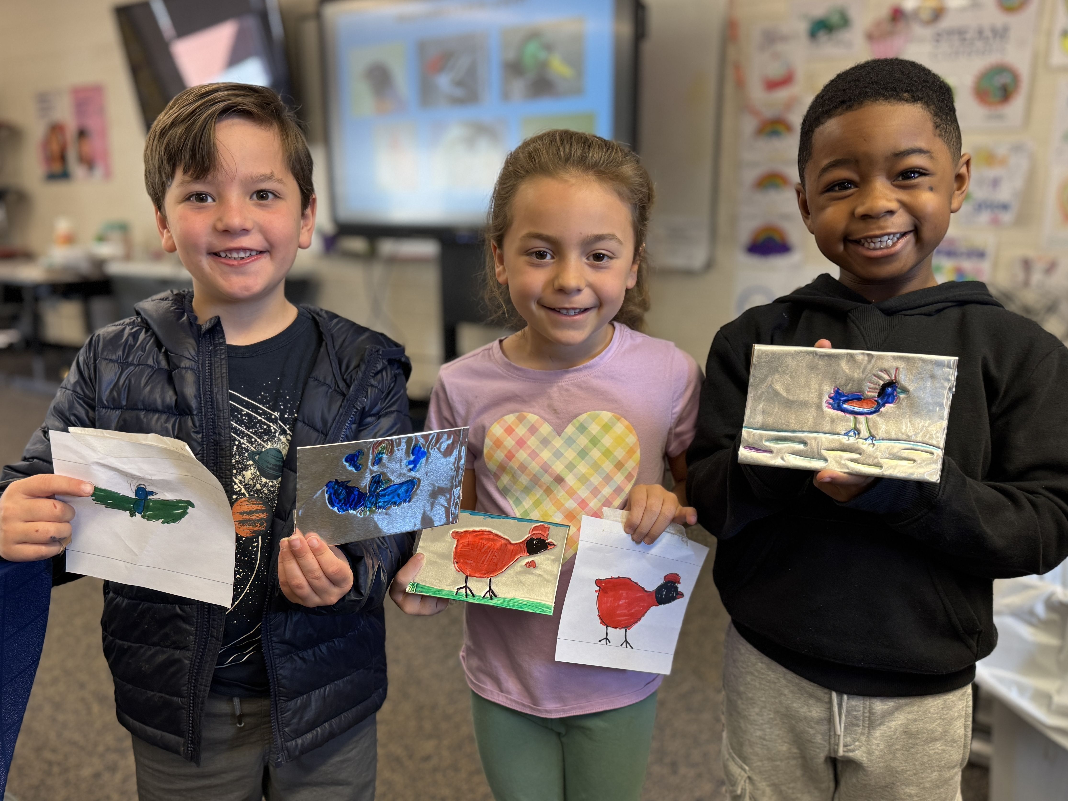 Excited students displaying their jeweled foil artwork