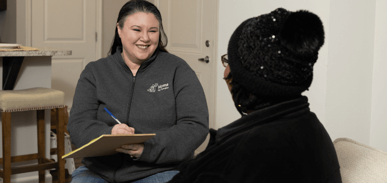 A case manager at Home for Families meets with a client to help them find housing