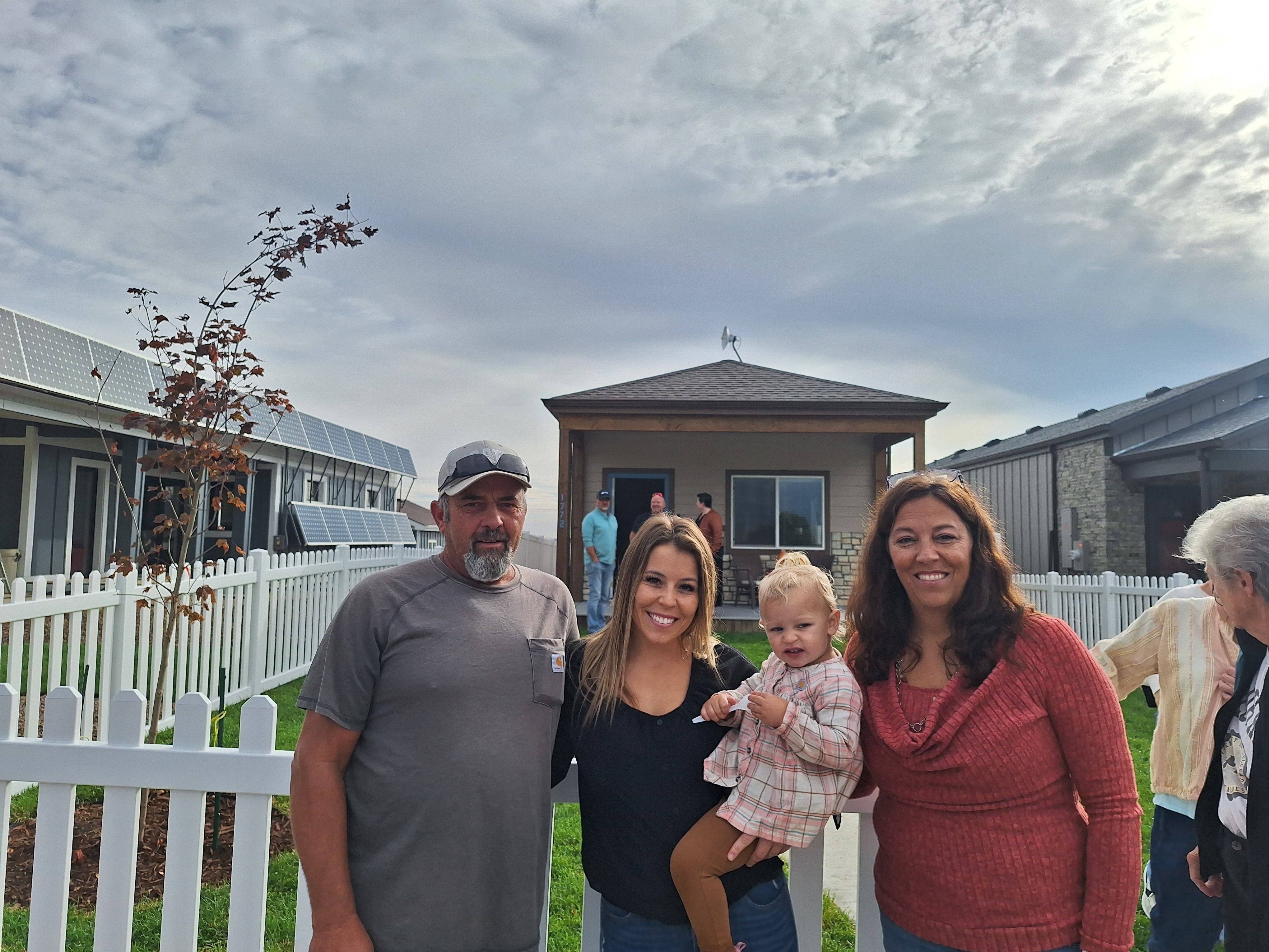 Addison and her family in front of her house.