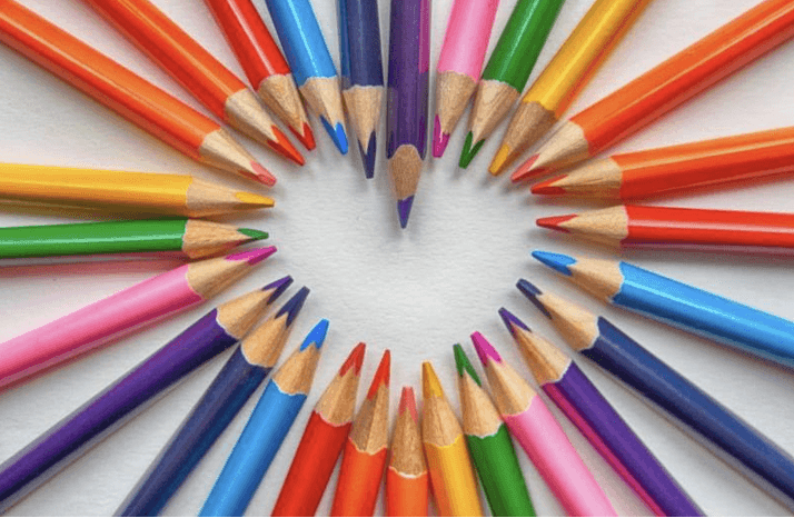 colored pencils rainbow in a heart shape