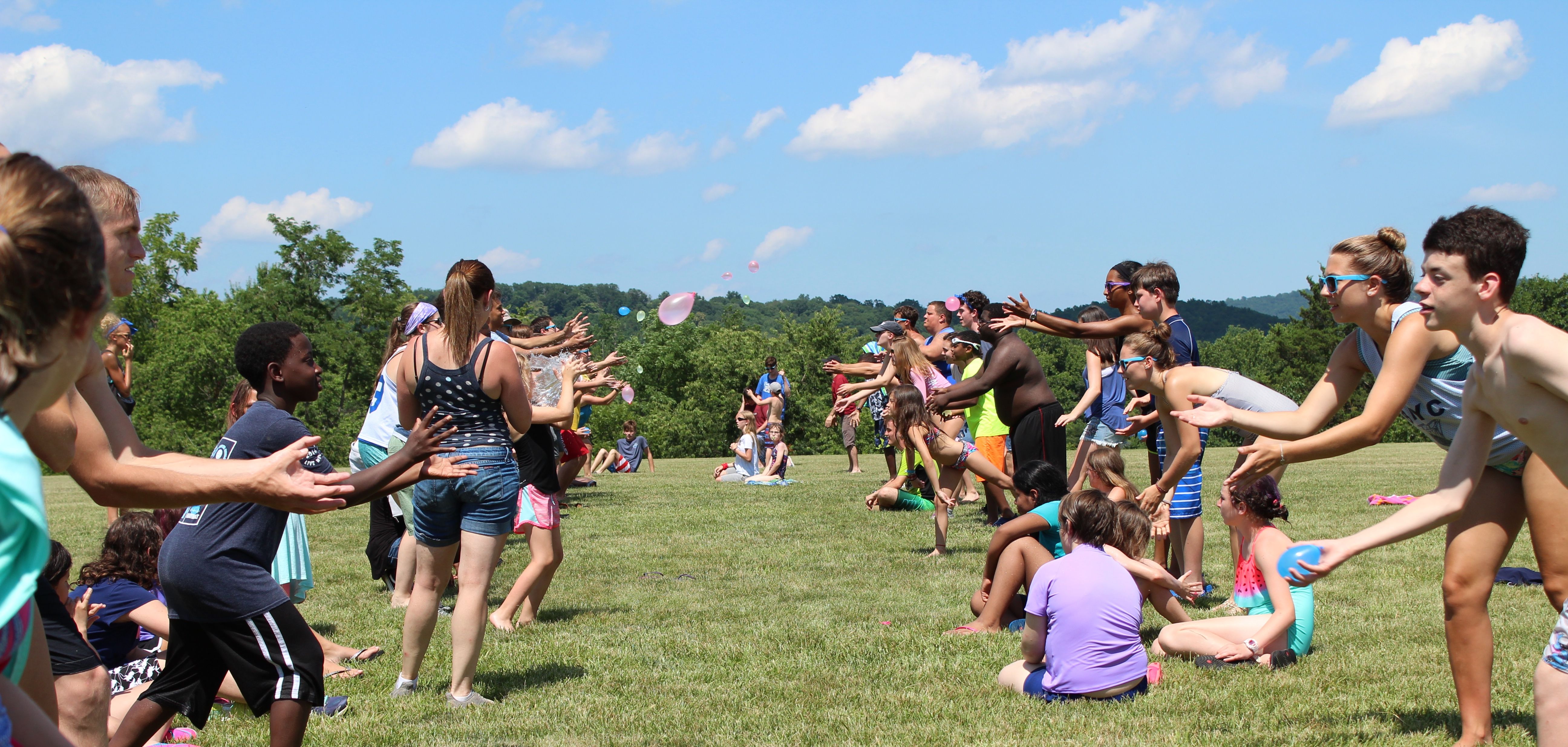 Campers play a balloon toss.