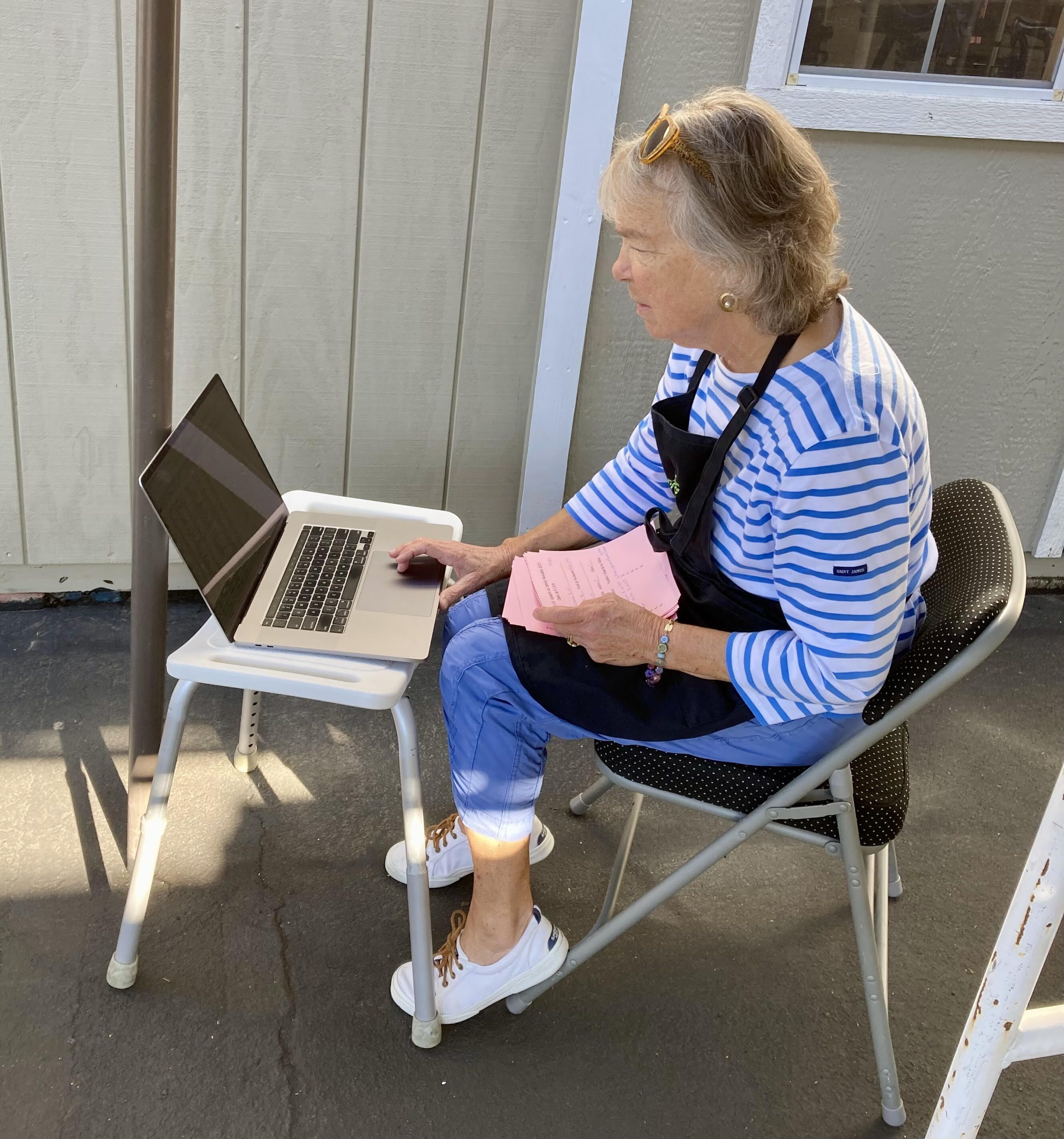 Photo of volunteer entering registrations in a laptop