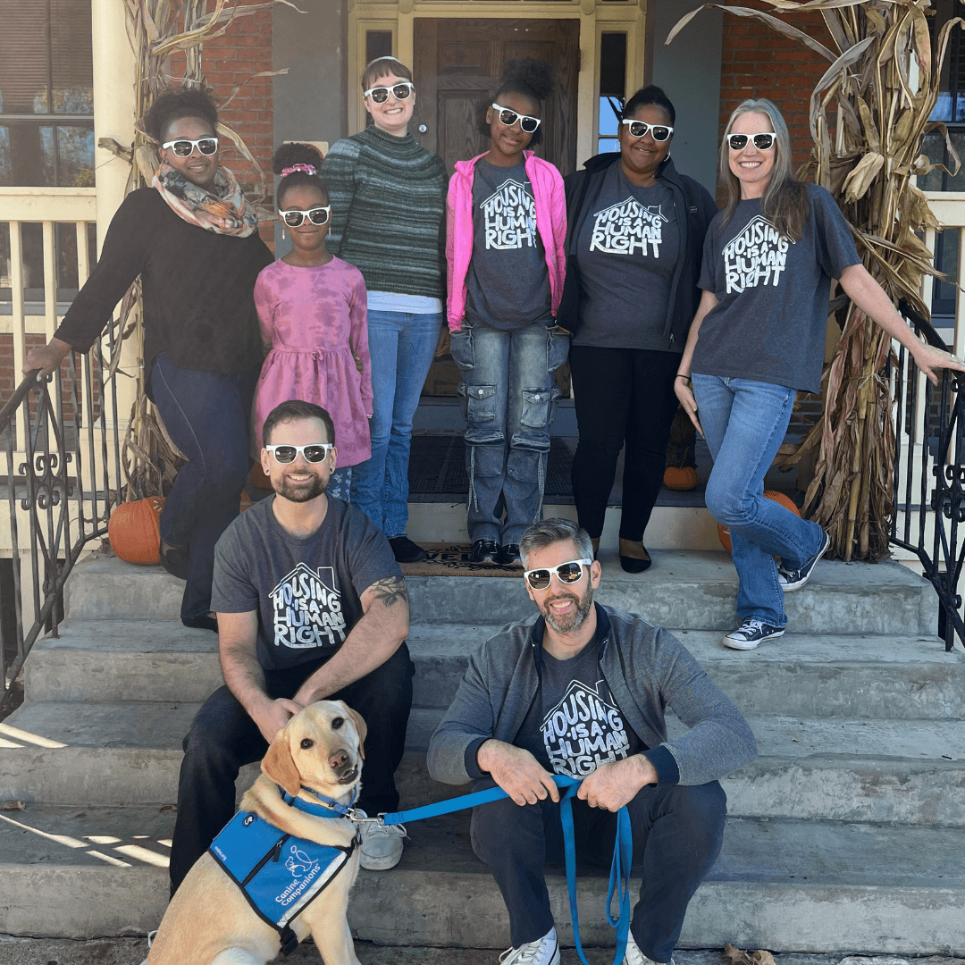Home for Families staff gather on the front steps of our office ahead of our Open House held in recognition of World Homeless Day.