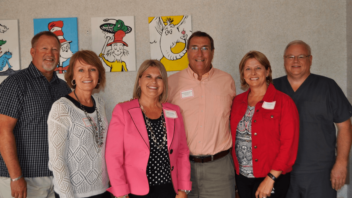 leaders posing at dental clinic grand opening