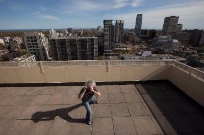 Lorne on rooftop taking a photograph