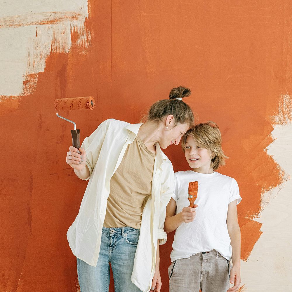 Mother and Son Painting Orange Wall
